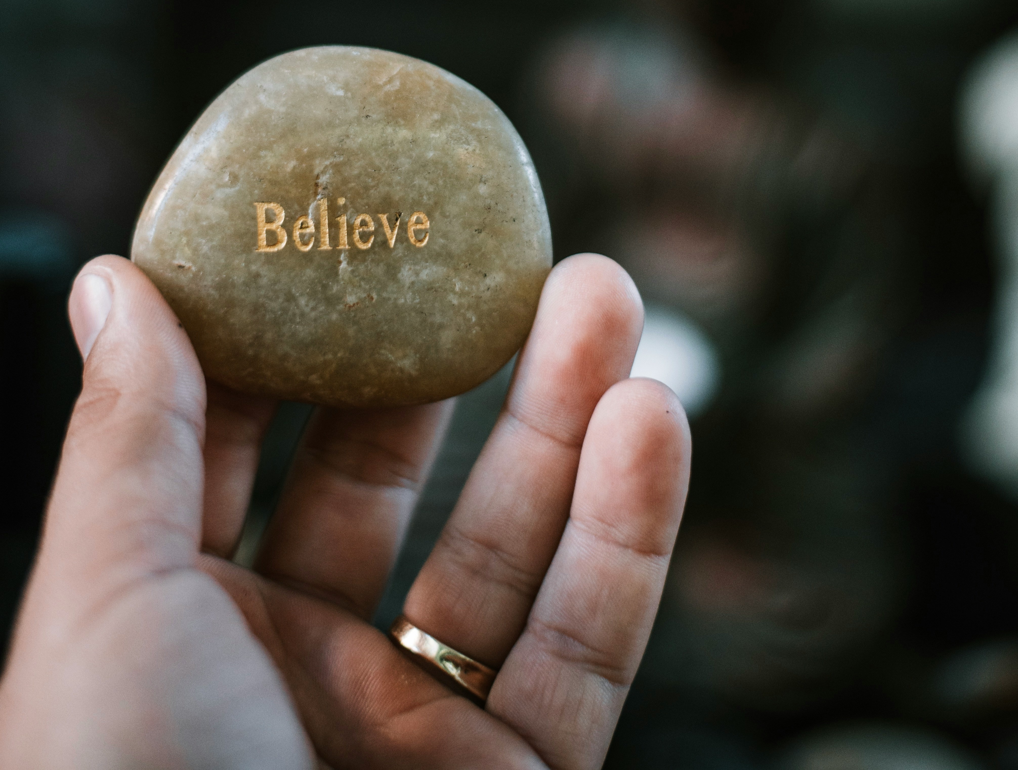 Believe stone held in hand